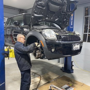 A Mini Cooper up on the lift for front-end service